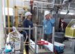 Two people standing in a lab talking