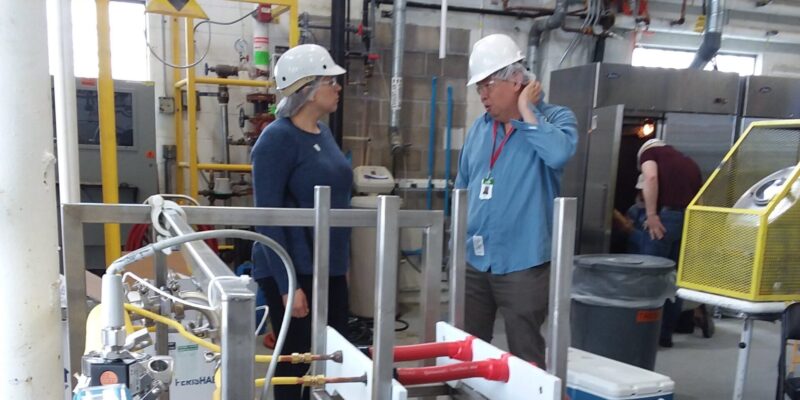 Two people standing in a lab talking