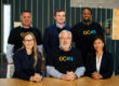 Six representatives from GCxN Cohort 6 sit at a table